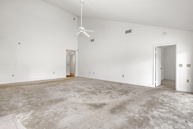 interior space featuring ceiling fan, light colored carpet, and high vaulted ceiling