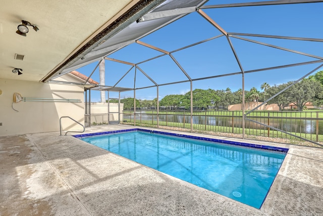 view of pool featuring a water view, a patio area, and a lanai