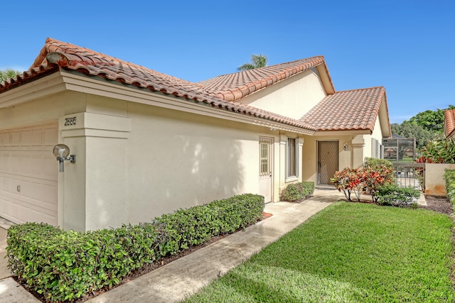 view of home's exterior with a garage and a yard