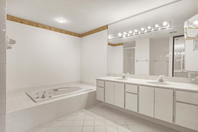 bathroom featuring vanity, shower with separate bathtub, and tile patterned floors