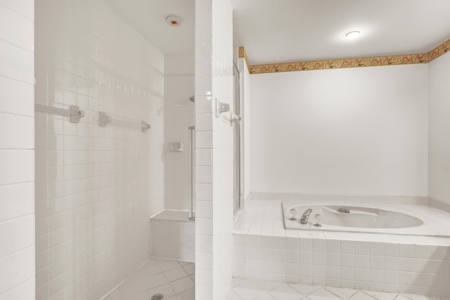 bathroom featuring shower with separate bathtub