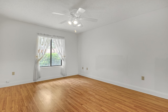 spare room featuring ceiling fan, a textured ceiling, and light hardwood / wood-style flooring