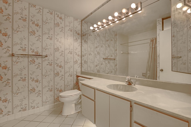 bathroom featuring tile patterned flooring, a shower with curtain, vanity, and toilet