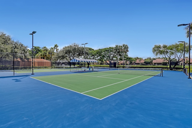 view of tennis court featuring basketball hoop