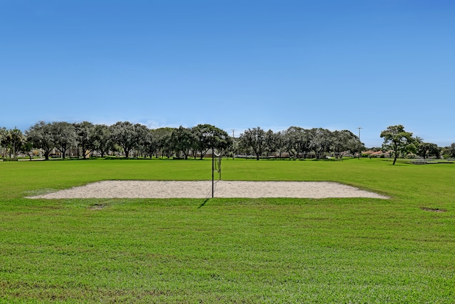 view of home's community featuring volleyball court and a yard