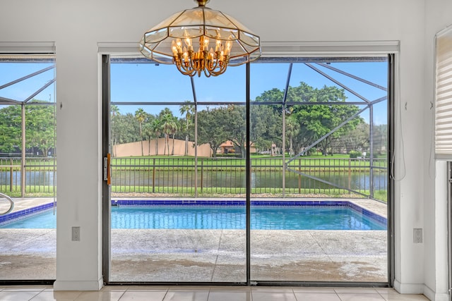 view of pool featuring a notable chandelier and a water view