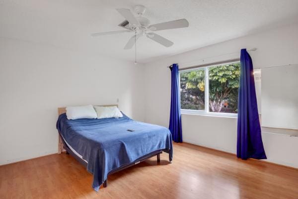 bedroom featuring ceiling fan and wood-type flooring