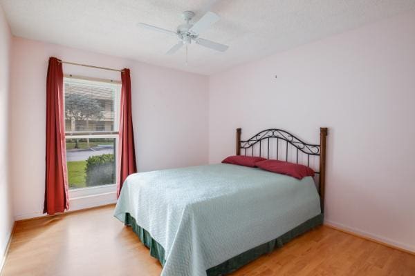 bedroom with hardwood / wood-style flooring and ceiling fan