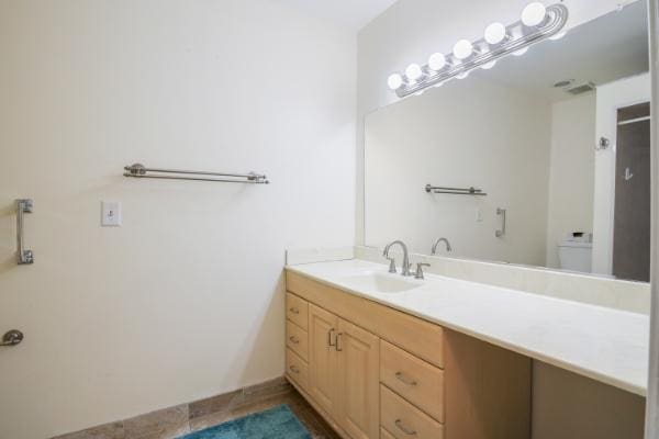 bathroom with tile patterned floors, vanity, and toilet