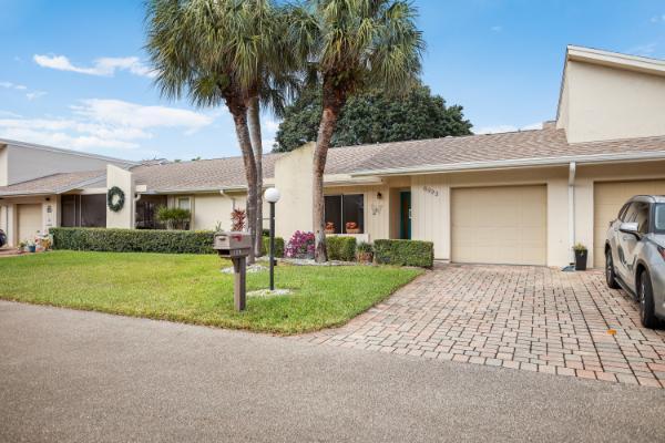 ranch-style house with a garage and a front lawn