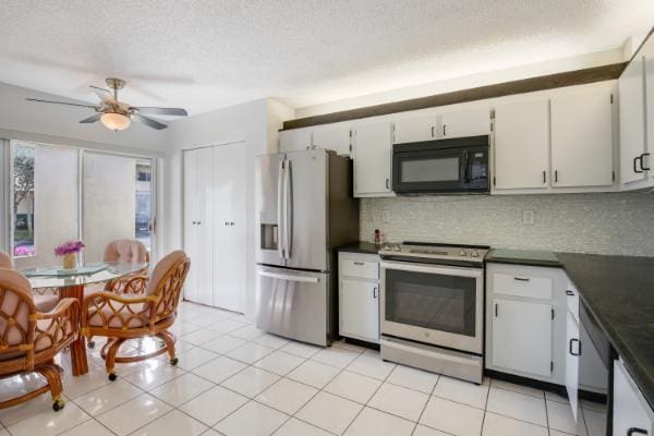 kitchen featuring white cabinets, ceiling fan, light tile patterned floors, tasteful backsplash, and stainless steel appliances