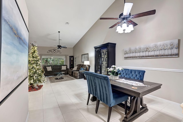 tiled dining room featuring high vaulted ceiling and ceiling fan