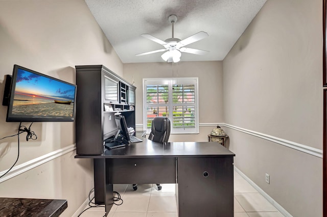 office featuring vaulted ceiling, light tile patterned floors, and a textured ceiling