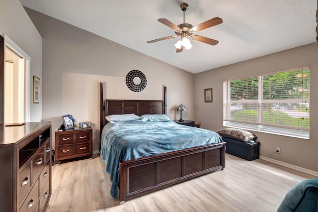 bedroom featuring ceiling fan, a textured ceiling, and light hardwood / wood-style floors