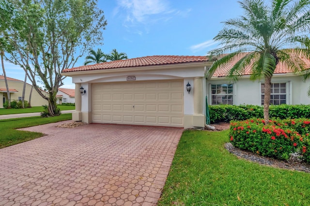 mediterranean / spanish-style house with a front lawn and a garage