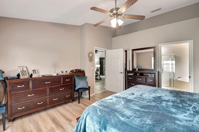 bedroom with ceiling fan, connected bathroom, and light hardwood / wood-style floors