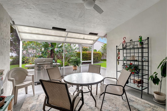 sunroom featuring ceiling fan and a wealth of natural light