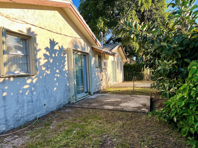 view of property exterior with a patio