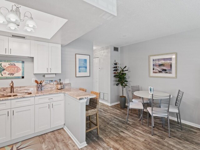 living room with sink and light hardwood / wood-style floors