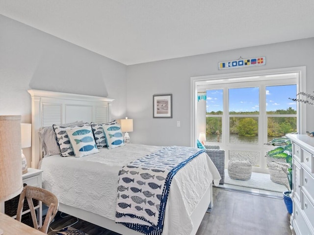 bedroom featuring dark hardwood / wood-style floors and access to exterior