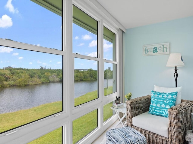 sunroom / solarium with a water view