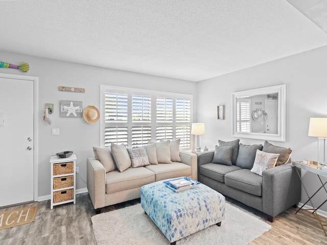 living room with hardwood / wood-style flooring and a textured ceiling