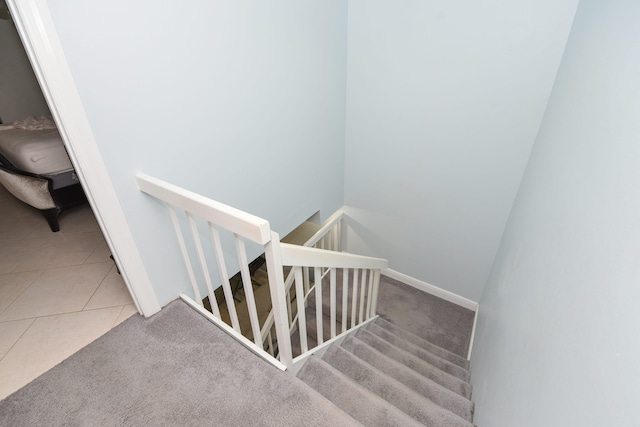 stairway featuring carpet