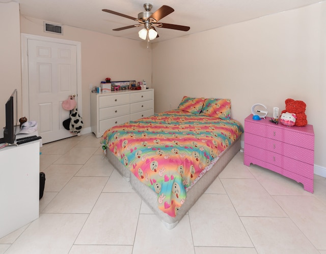 tiled bedroom with ceiling fan