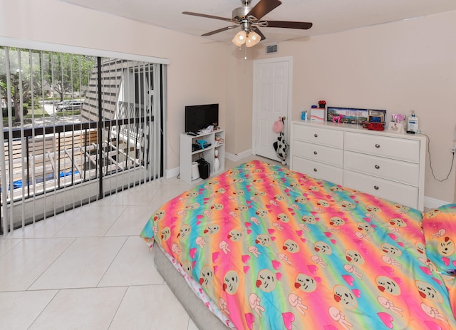 tiled bedroom featuring ceiling fan