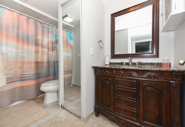 bathroom featuring a shower with curtain, vanity, toilet, and tile patterned floors