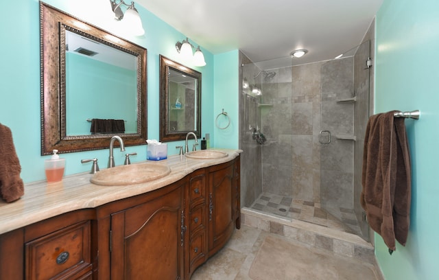 bathroom featuring tile patterned flooring, walk in shower, and vanity