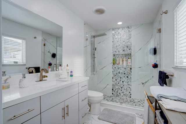 bathroom with vanity, a shower with shower door, and toilet