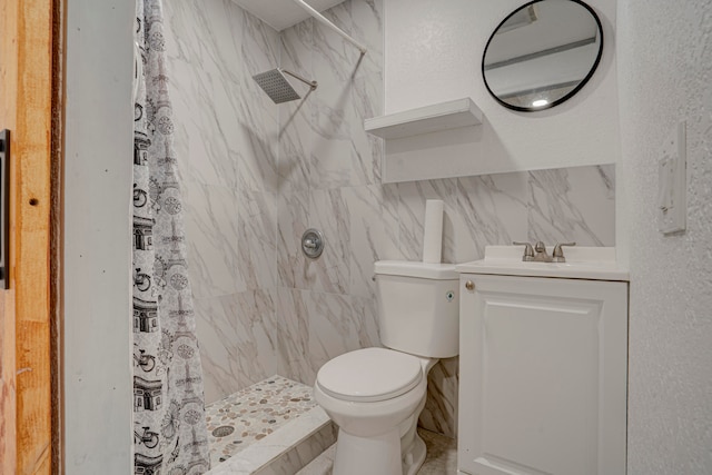 bathroom with vanity, tile walls, toilet, and curtained shower