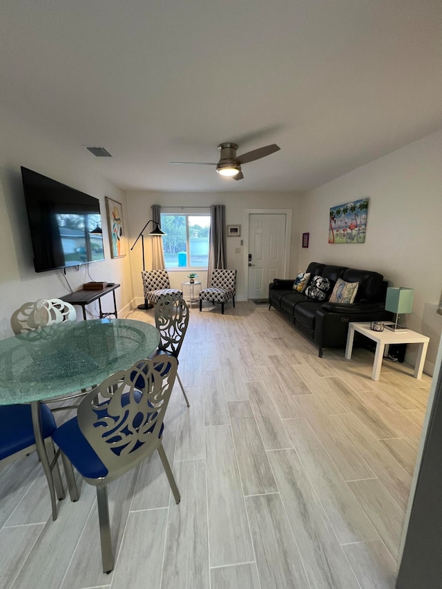 living room featuring ceiling fan and wood-type flooring