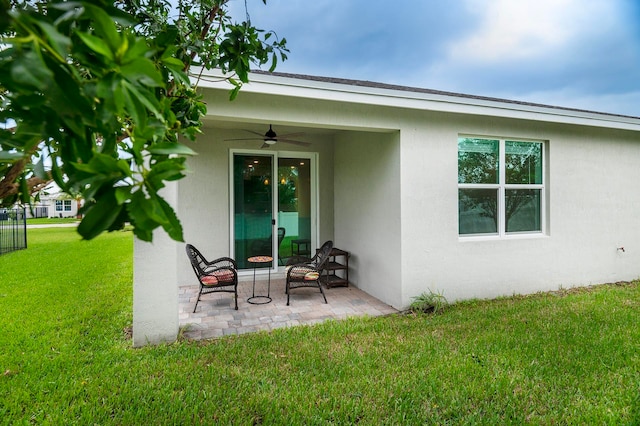 back of house featuring a yard, ceiling fan, and a patio area