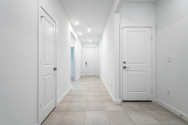 corridor featuring light tile patterned floors