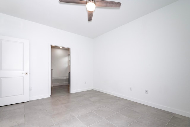 empty room featuring ceiling fan and light tile patterned floors