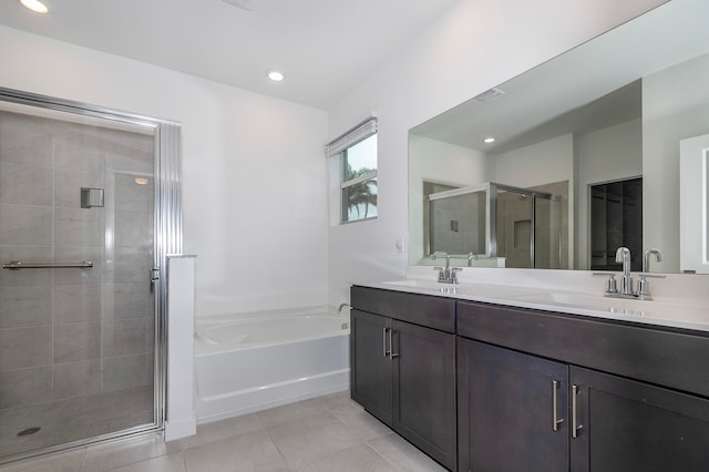 bathroom featuring tile patterned flooring, vanity, and plus walk in shower