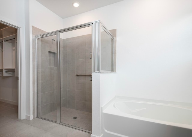 bathroom featuring plus walk in shower and tile patterned floors