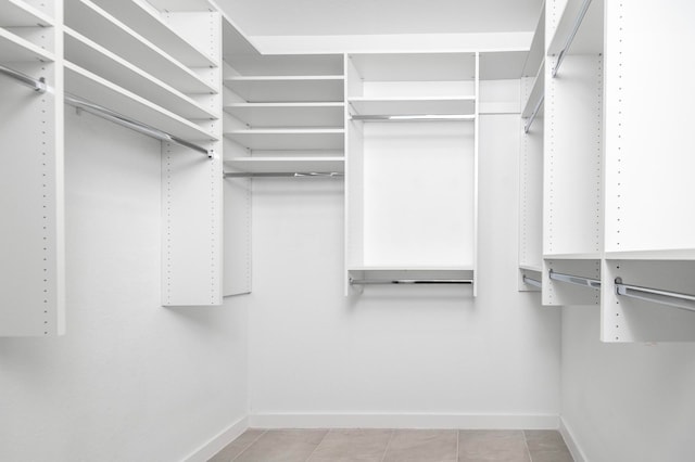 walk in closet featuring light tile patterned flooring