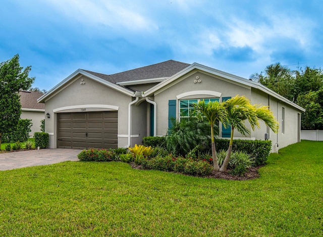 ranch-style home with a front lawn and a garage