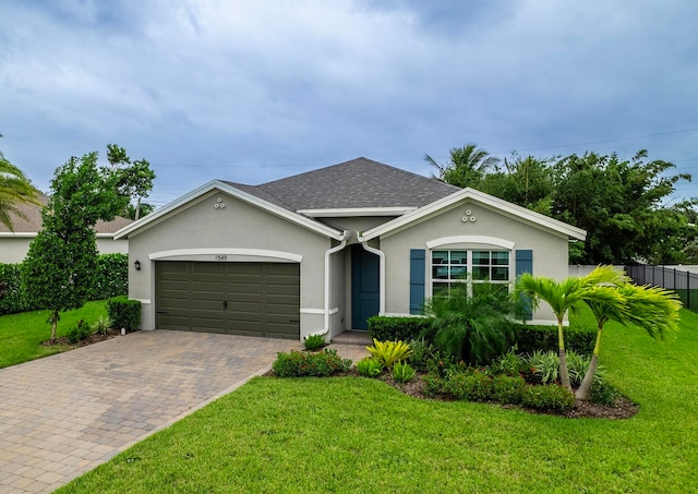 ranch-style house featuring a garage and a front yard