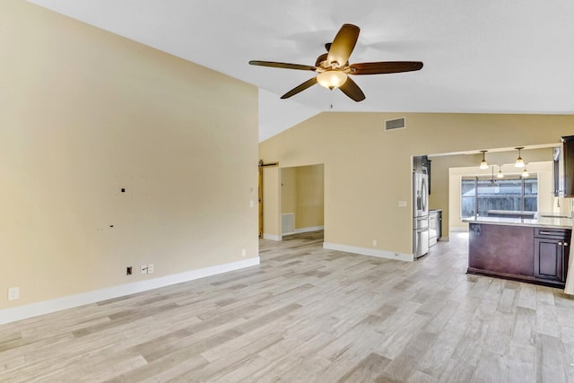 unfurnished living room featuring ceiling fan, light wood-type flooring, and lofted ceiling