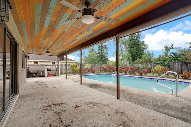 view of swimming pool featuring an outdoor bar and a patio