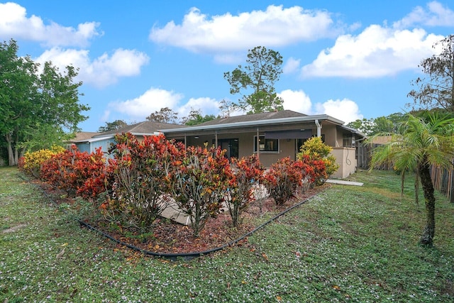 rear view of house with a lawn