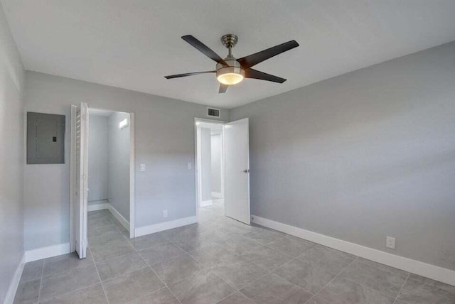 632 Monaco N, Delray Beach, FL 33446 - unfurnished bedroom featuring electric panel, baseboards, a ceiling fan, and light tile patterned floors