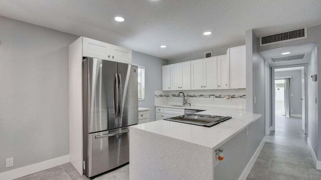 632 Monaco N, Delray Beach, FL 33446 - kitchen featuring freestanding refrigerator, black electric stovetop, a peninsula, plenty of natural light, and recessed lighting