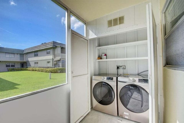 632 Monaco N, Delray Beach, FL 33446 - washroom with washer and dryer and tile patterned flooring