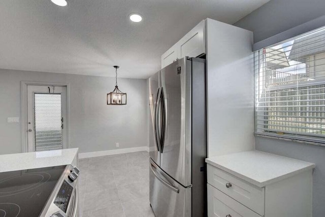 632 Monaco N, Delray Beach, FL 33446 - kitchen with freestanding refrigerator, electric stove, white cabinetry, a chandelier, and a textured ceiling