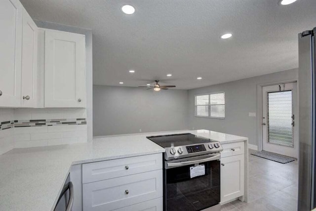 632 Monaco N, Delray Beach, FL 33446 - kitchen featuring stainless steel range with electric cooktop, a peninsula, recessed lighting, white cabinetry, and a ceiling fan
